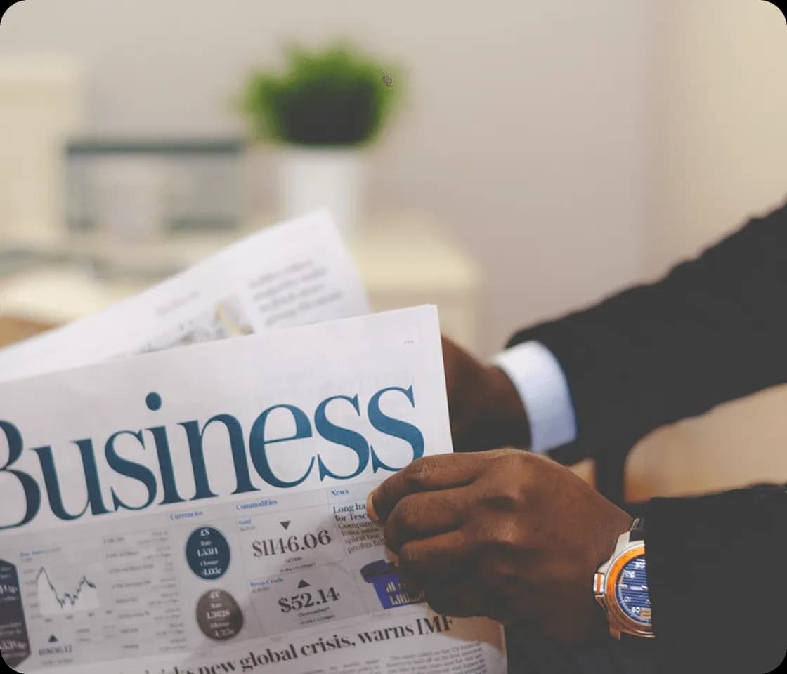 Person analyzing corporate growth business newspaper metrics